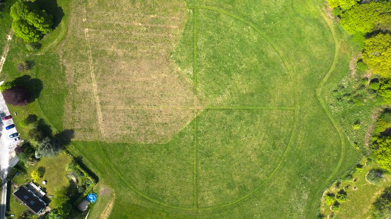 A mown cross within a circle in a large field